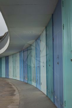 Beach huts curving into the distance on a beach in Torquay image