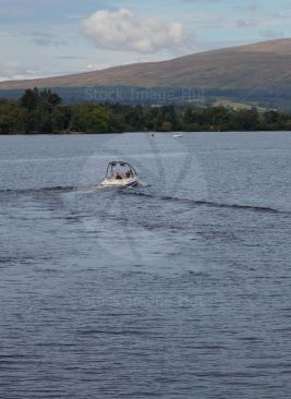 Couple enjoying a day on loch lomond in their powerboat