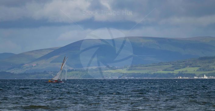 A racing yacht during the Fife regatta enjoying the windy conditions