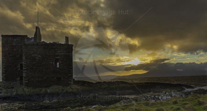 Portencross castle on the West Coast of Scotland as sun begins to set on a cold January Afternoon