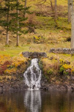 A very small waterfall coming from fields in winter