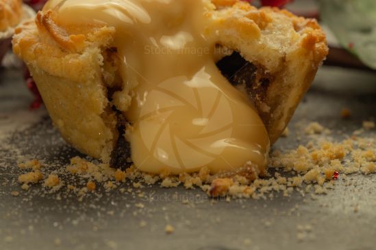 A close-up shot of delicious Christmas mince pie and custard, just getting ready for the festive season.