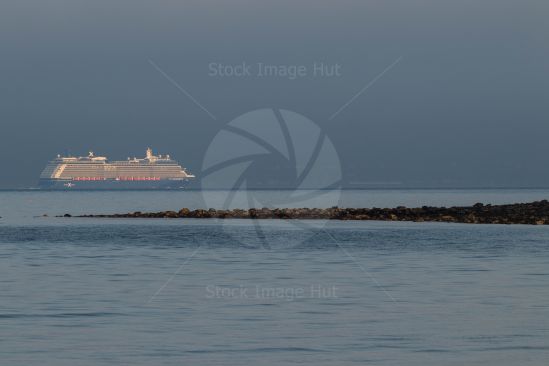 A large cruise liner sailing close to the coast as she heads for port in Greenock, Scotland