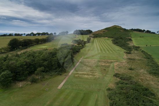 Looking down on golf course from 130 feet up as rain starts to fall