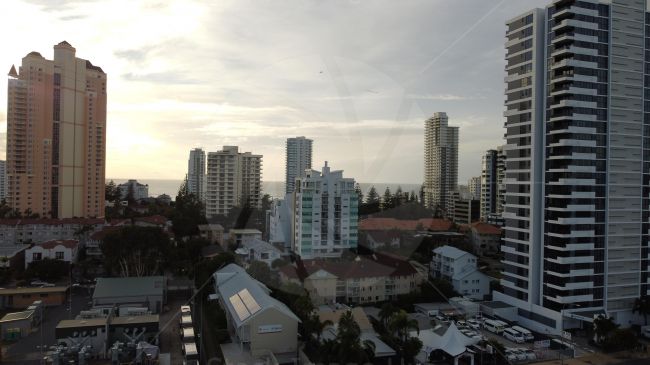 Drone image of buildings and offices in Queensland Australia, you can just see a little plane in distance pulling a banner