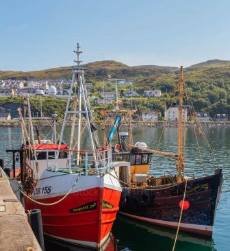 Two small fishing boats moored in Scottish fishing port of Mallaig