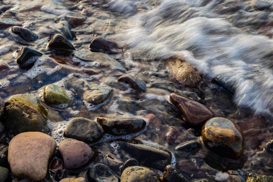 Waves rushing over pebbles on beach