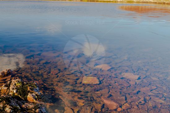 Ice forming on loch on a winter day