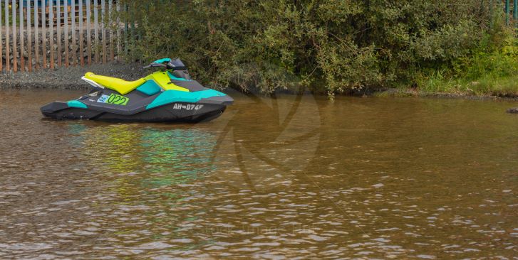 Brightly coloured jet-ski sitting on loch lomond