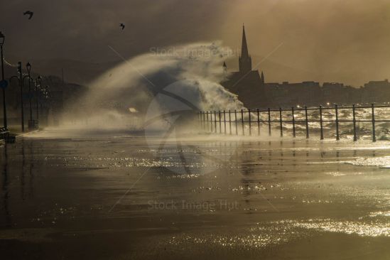 Massive waves crash into promenade during a storm image