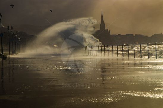 Massive waves crash into promenade during a storm