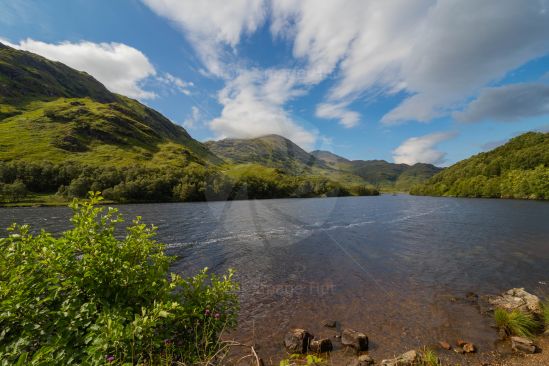 Looking across a loch with a stunning backdrop of mountains in the Scottish highlands