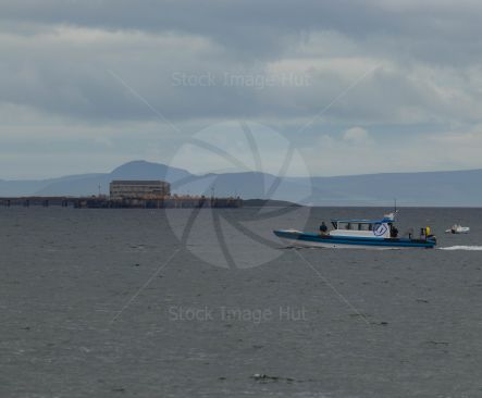 Small passenger boat returning to port after droping off crew to their yachts during Fife regatta