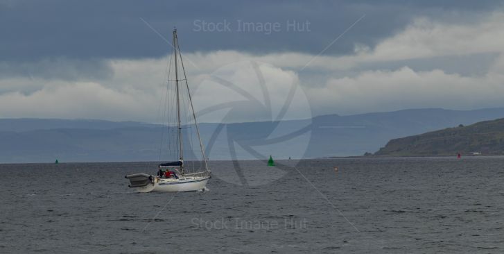 Yacht with Rib on back heading out to sea
