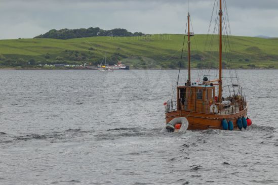 A fantastic wooden boat towing a Rib