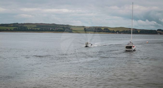 Yacht and powerboat passing each other on a nice calm day