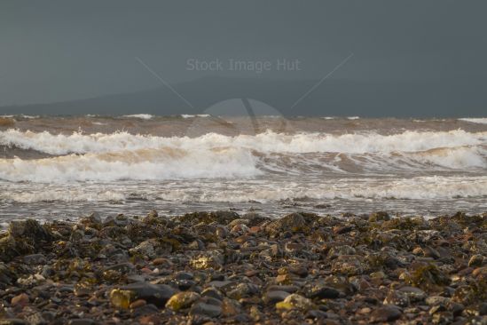 Storm coming in on Scottish seaside, you can just make out the distant mountains