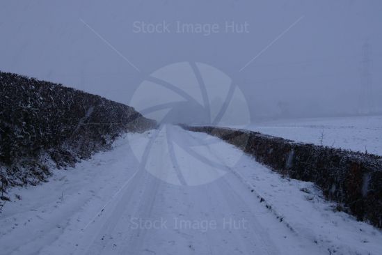 Heavy snow falling on countryside road  on the West Coast of Scotland