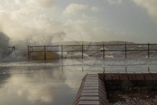 Large waves hitting seafront on stormy day