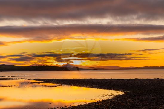 Beautiful sunset over sea reflecting on water surface