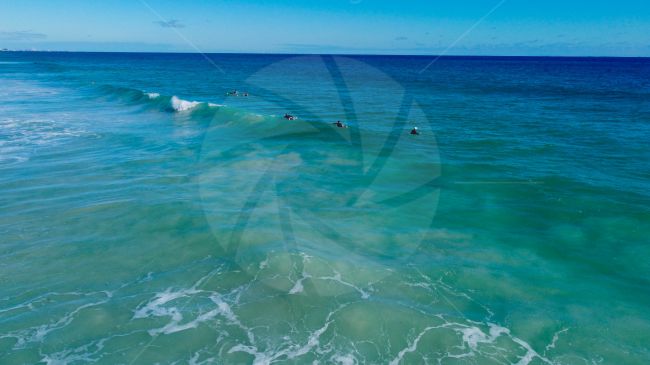 Surfers at Scaraborough beach enjoying the waves on a lovely day, WA