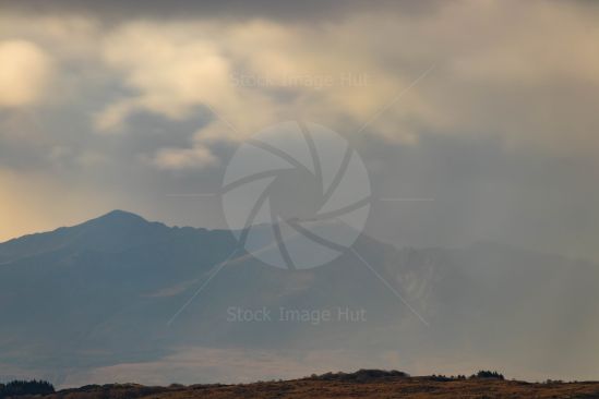 Weather front coming in across distant mountains