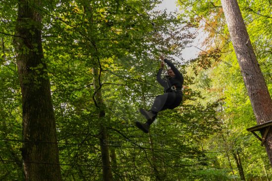 Enjoying woodland fun on a zip-line through the trees